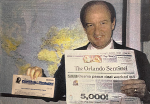 Mark Skousen holding a newspaper